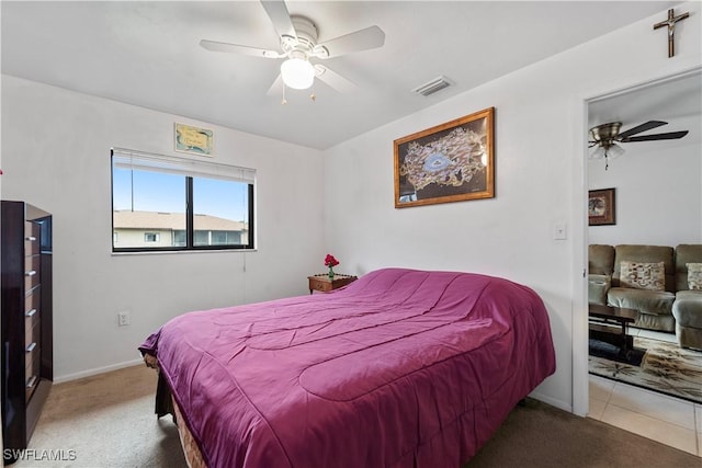 bedroom with ceiling fan and light colored carpet