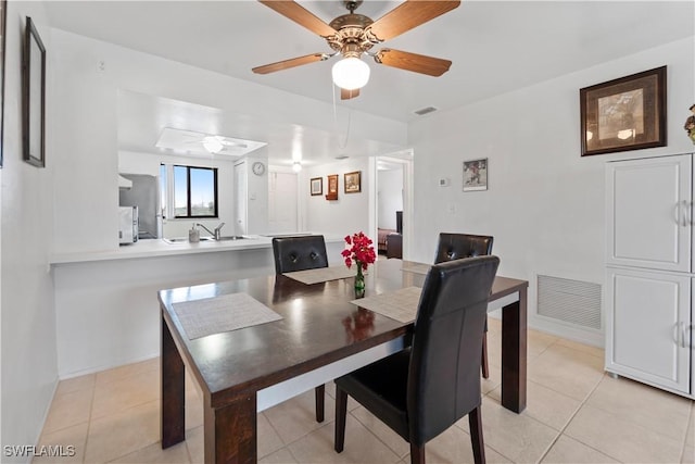 tiled dining room with ceiling fan