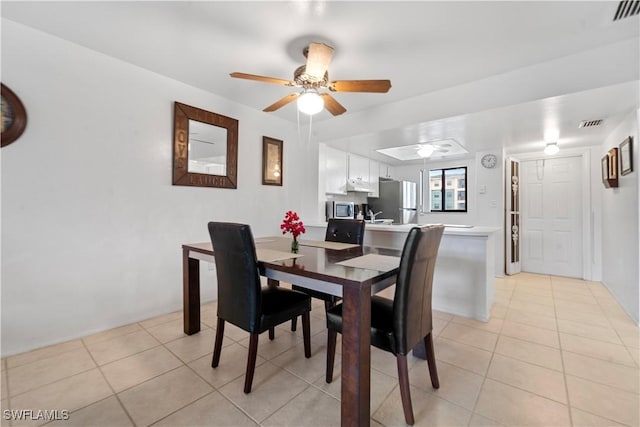 dining area with light tile patterned flooring and ceiling fan