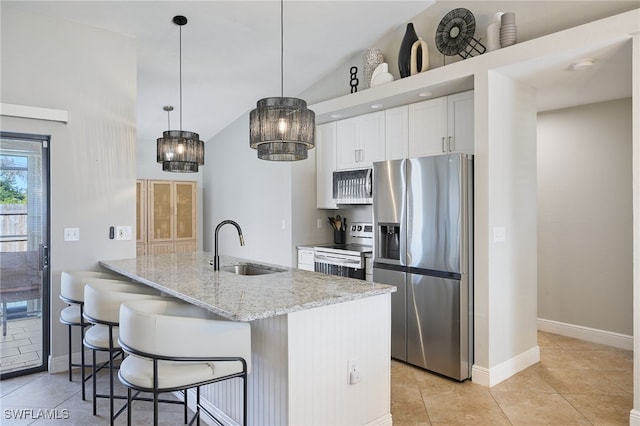 kitchen featuring pendant lighting, sink, white cabinets, stainless steel appliances, and light stone countertops