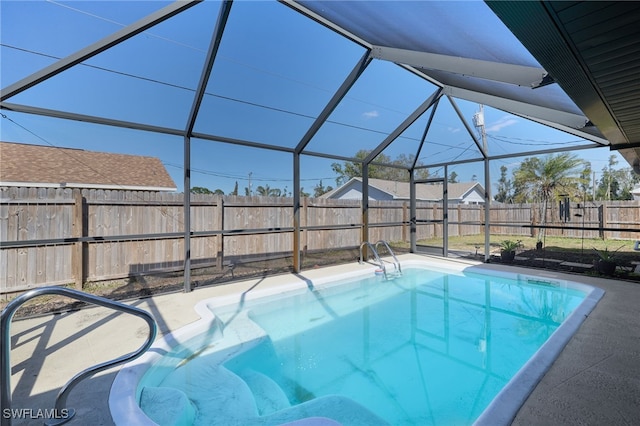 view of pool featuring glass enclosure