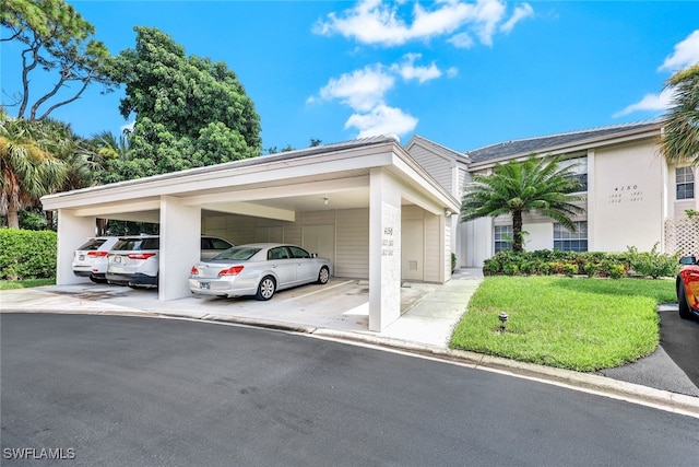 view of parking / parking lot with a lawn