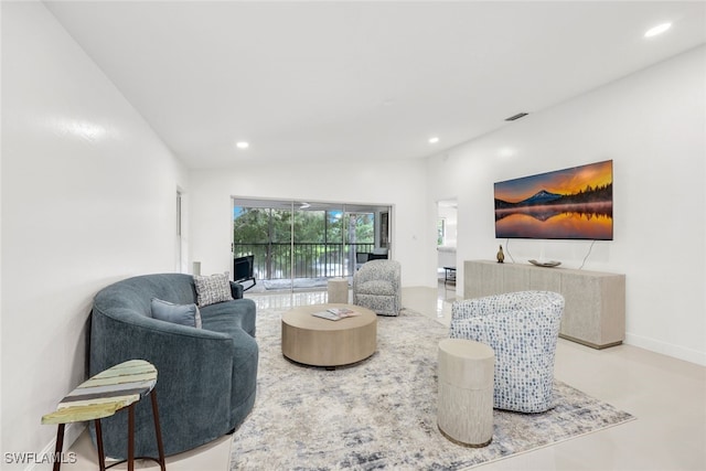 living area with baseboards, visible vents, vaulted ceiling, and recessed lighting