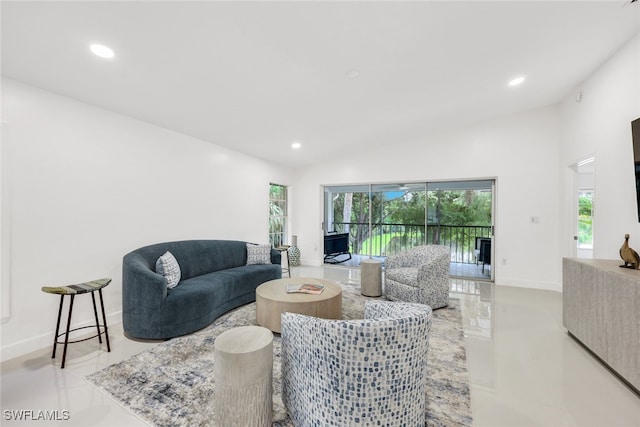 living room with lofted ceiling, recessed lighting, baseboards, and a healthy amount of sunlight