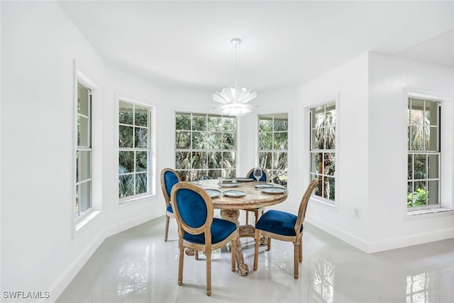 interior space featuring an inviting chandelier and baseboards