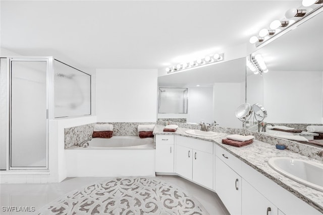 bathroom with vanity, independent shower and bath, and tile patterned flooring