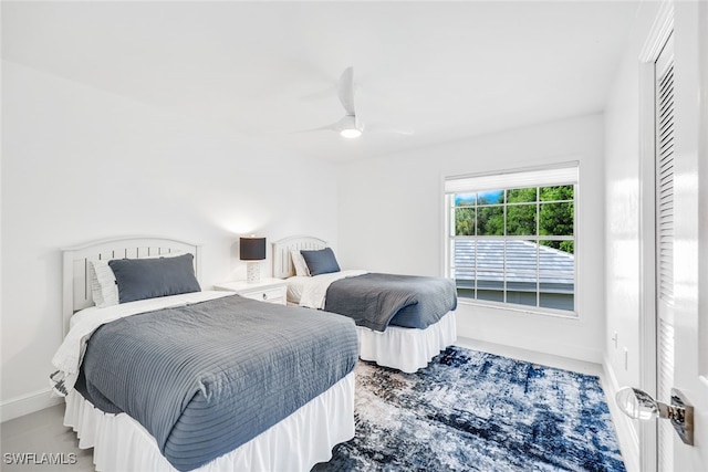 bedroom featuring a ceiling fan and baseboards