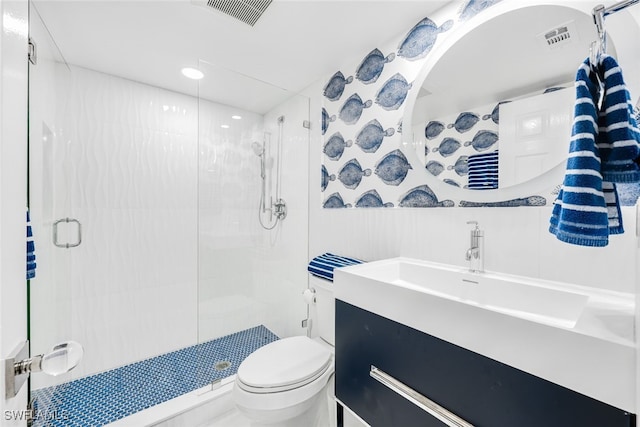 full bathroom featuring toilet, a wainscoted wall, vanity, visible vents, and a shower stall