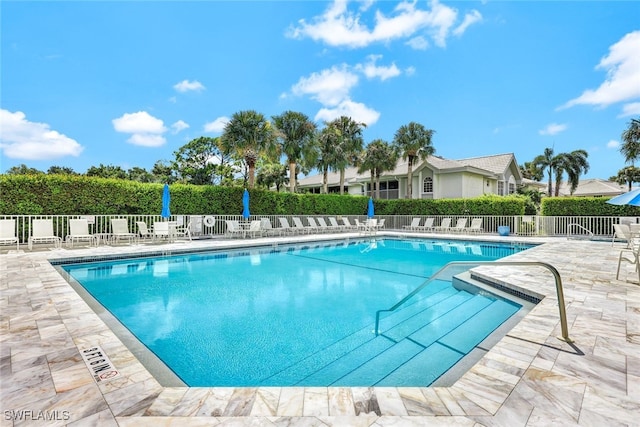 pool with fence and a patio