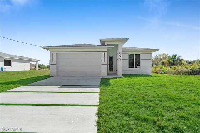 view of front of property with a garage and a front lawn