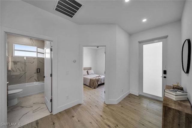 bathroom with walk in shower, wood-type flooring, and toilet