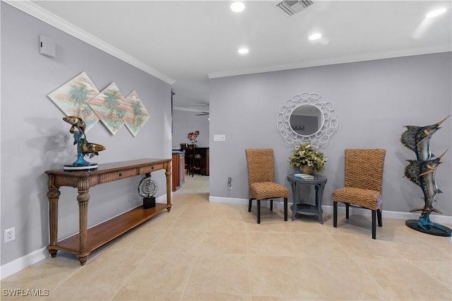 sitting room with crown molding and light tile patterned floors