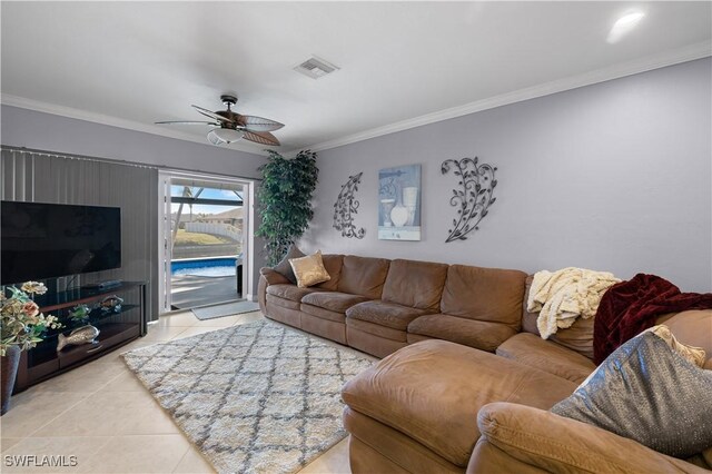 tiled living room with ornamental molding and ceiling fan