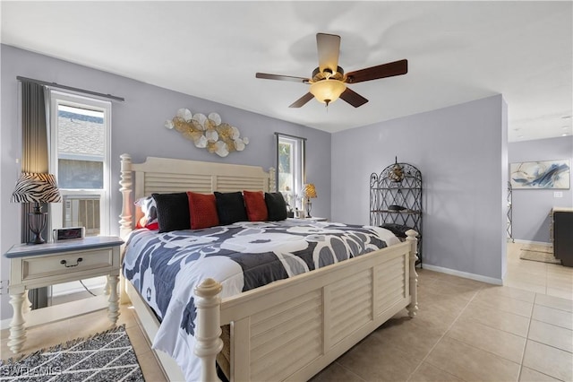 bedroom with multiple windows, ceiling fan, and light tile patterned flooring