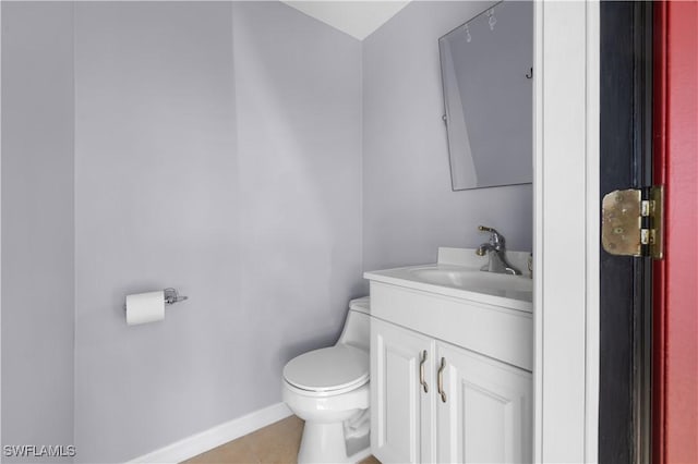 bathroom featuring vanity, toilet, and tile patterned flooring