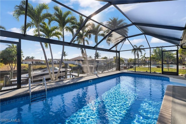 view of swimming pool featuring glass enclosure