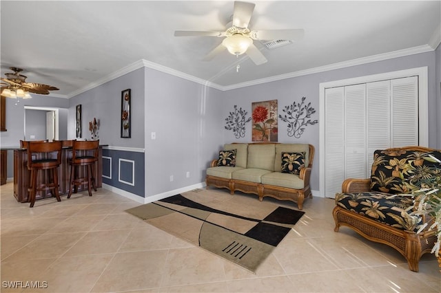 living room with bar, crown molding, ceiling fan, and light tile patterned flooring