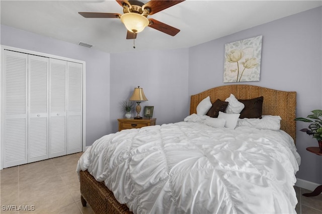 bedroom with a closet, ceiling fan, and light tile patterned flooring