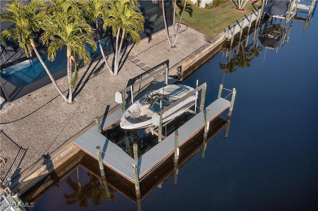 view of dock featuring a water view and a yard