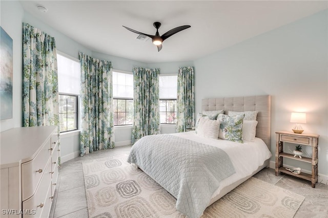 bedroom with ceiling fan and light tile patterned floors