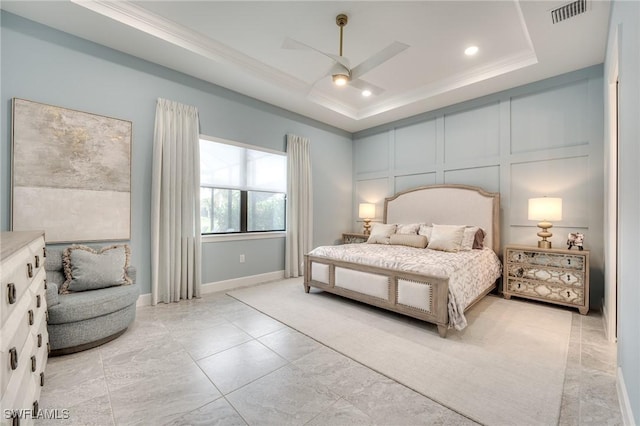 bedroom featuring a tray ceiling, ornamental molding, and ceiling fan