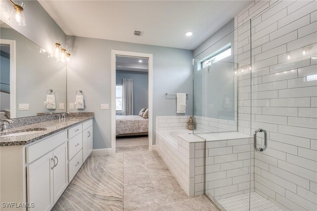 bathroom with shower with separate bathtub, plenty of natural light, and vanity