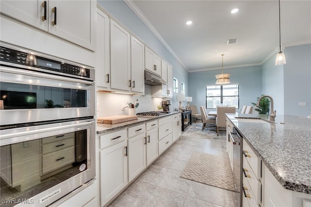 kitchen featuring sink, white cabinetry, hanging light fixtures, stone counters, and stainless steel appliances