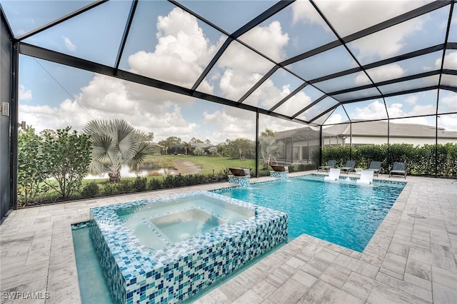 view of swimming pool featuring a patio, a water view, glass enclosure, pool water feature, and an in ground hot tub