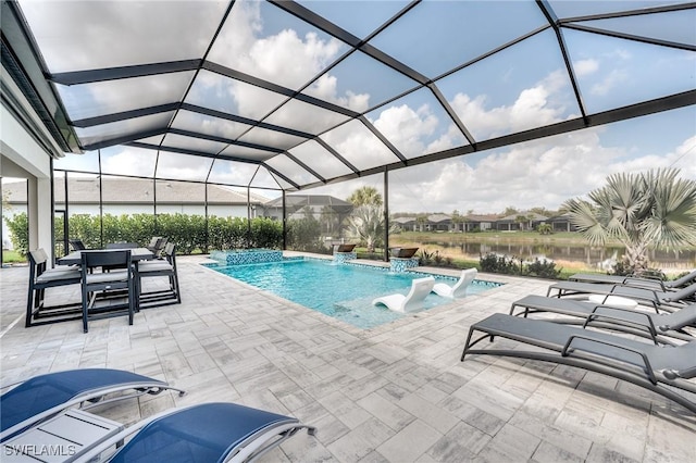 view of pool featuring a patio area, a water view, pool water feature, and glass enclosure