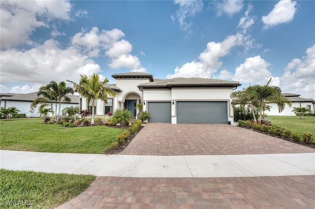 mediterranean / spanish house featuring a garage and a front lawn