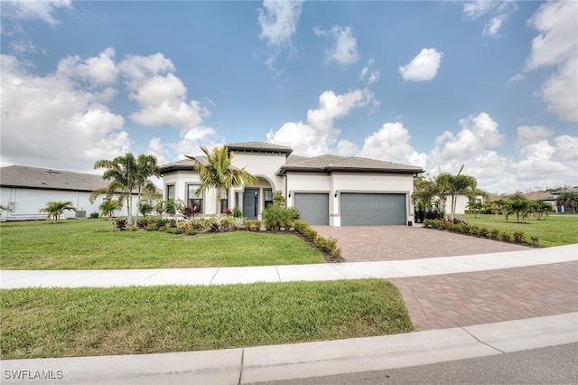 view of front of property featuring a garage and a front lawn