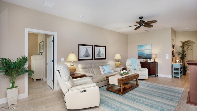 living room with light hardwood / wood-style floors and ceiling fan