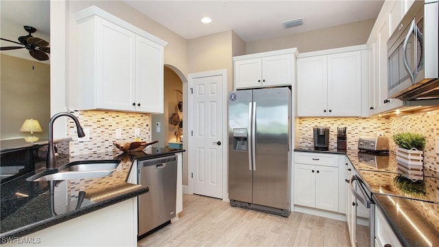 kitchen featuring sink, stainless steel appliances, and white cabinets