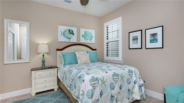 bedroom with wood-type flooring and ceiling fan