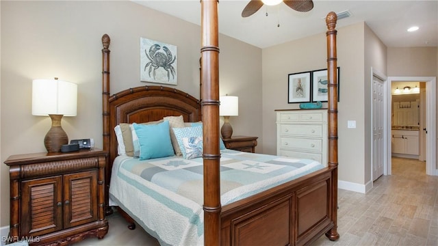 bedroom featuring light hardwood / wood-style flooring, connected bathroom, and ceiling fan