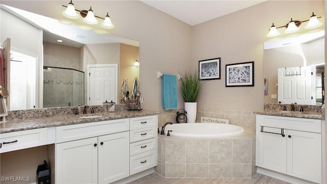 bathroom featuring tile patterned floors, vanity, and separate shower and tub