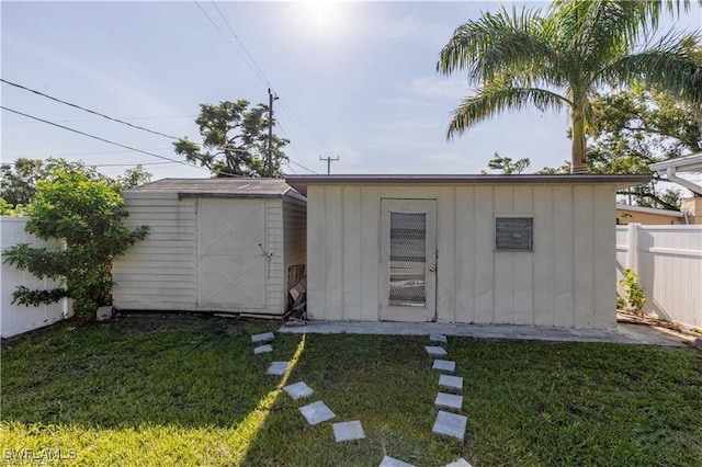 view of outbuilding with a lawn