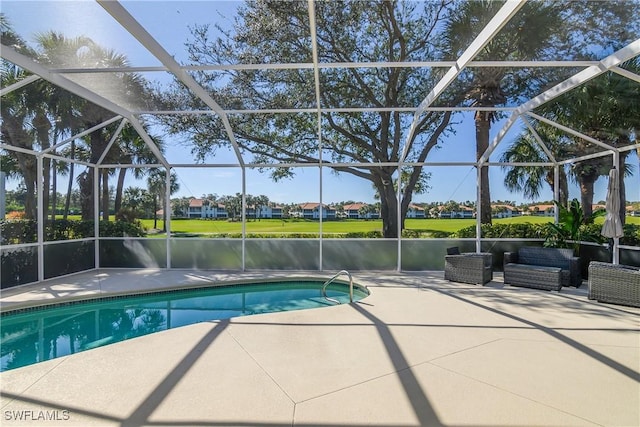 view of pool featuring an outdoor hangout area, a patio area, a water view, and glass enclosure