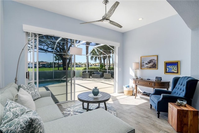 living room with light hardwood / wood-style floors and ceiling fan