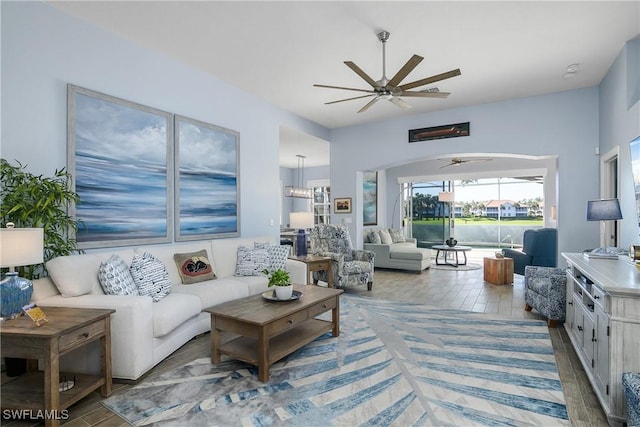 living room with wood-type flooring and ceiling fan