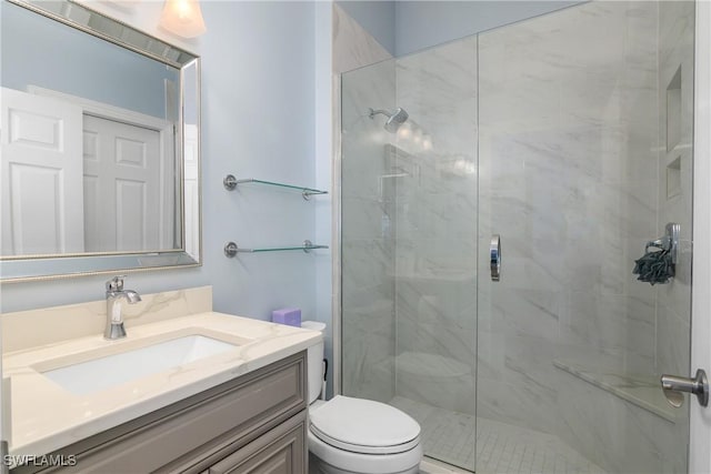 bathroom featuring vanity, an enclosed shower, and toilet