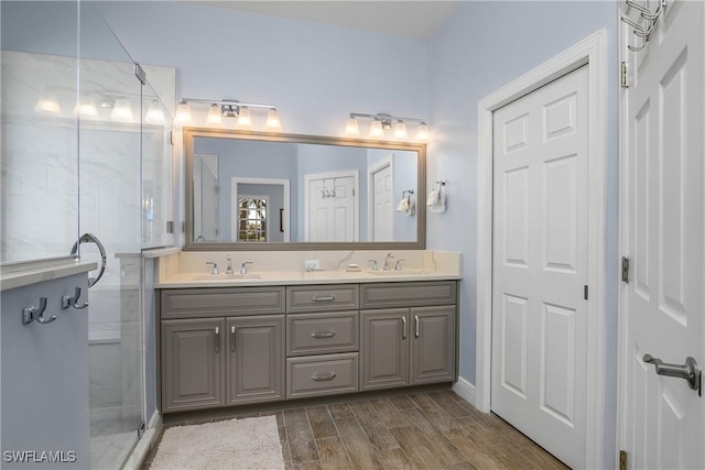 bathroom with an enclosed shower and vanity