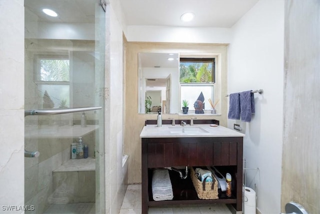 bathroom with vanity and a shower with door