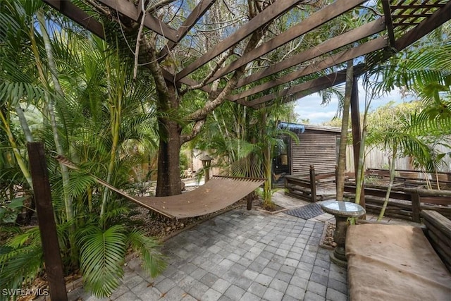 view of patio / terrace featuring a shed and a pergola