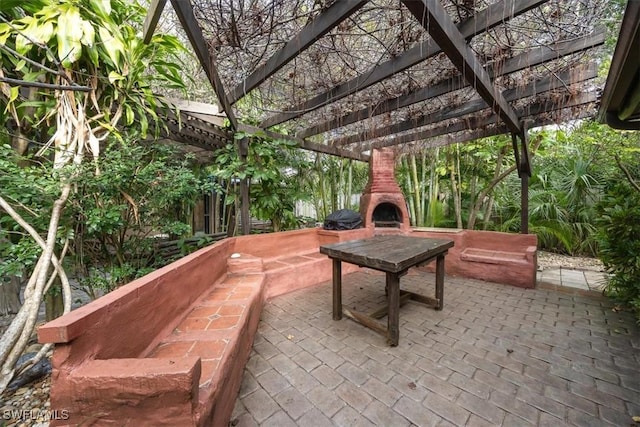 view of patio / terrace featuring an outdoor fireplace and a pergola