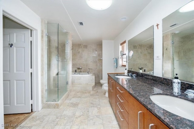 full bathroom featuring independent shower and bath, vanity, and toilet