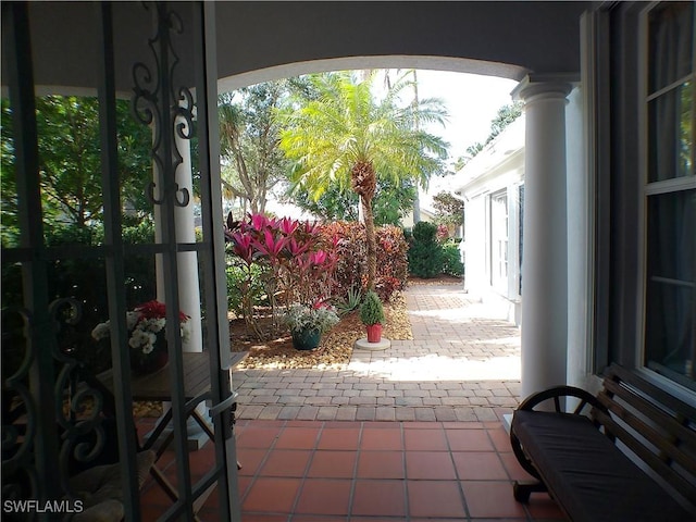 entryway with tile patterned flooring and ornate columns