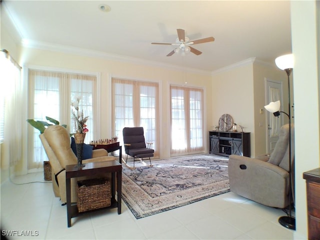 tiled living room featuring crown molding, ceiling fan, and a healthy amount of sunlight