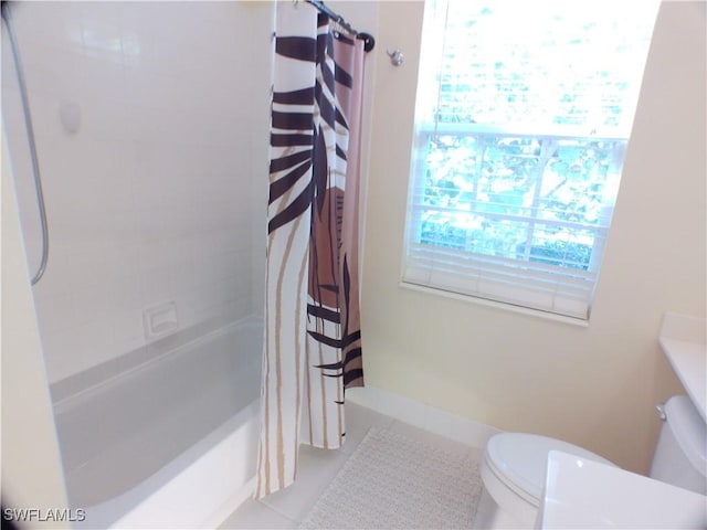 bathroom featuring shower / bath combination with curtain, toilet, and tile patterned flooring