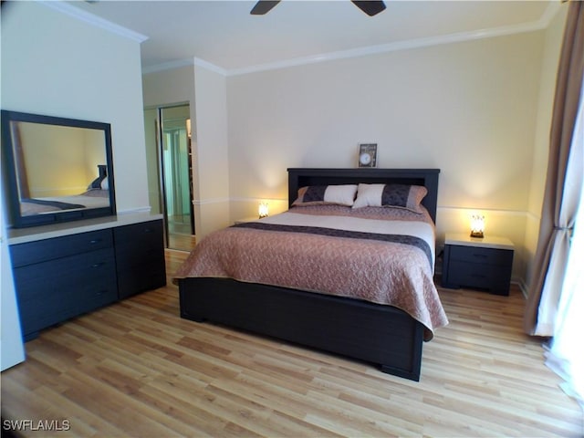 bedroom with crown molding, ceiling fan, and light hardwood / wood-style floors